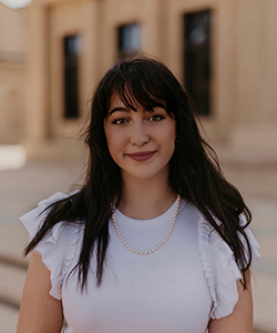 Bellah Bultron's headshot wearing a white blouse taken near the LSU Memorial Tower